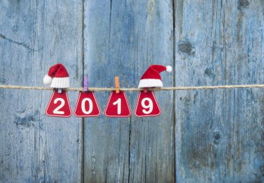 İki bin ve on dokuz metin kahverengi ip üzerinde ahşap duvar asılı. Mutlu yeni yıl kavramı