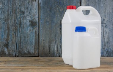 ahşap arka plan üzerinde farklı yapılandırma plastik galon çifti