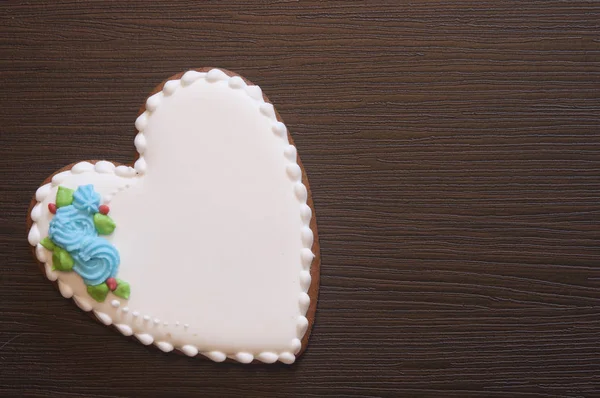 Gingerbread heart cookies on a wooden brown background