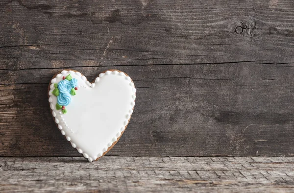 Gingerbread heart cookies on a wooden brown background