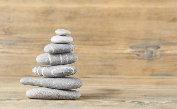 stack of smooth balanced pebble zen style still life on old wood 