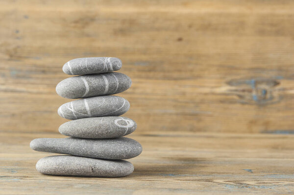 stack of smooth balanced pebble zen style still life on old wood 