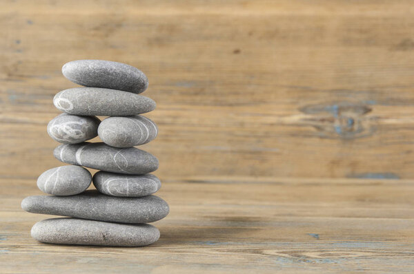 stack of smooth balanced pebble zen style still life on old wood 