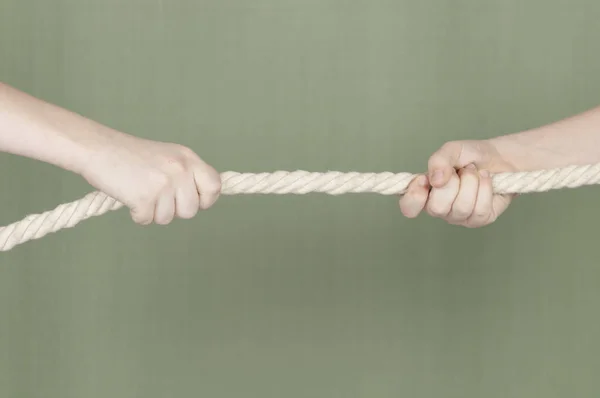 Children pulling the rope - close up on hands of young competitors