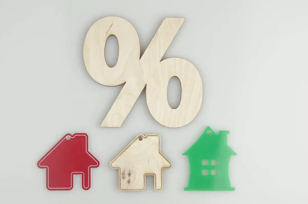Relocation and house hunting concept. Model of wooden house with sign percent on white background. Top View