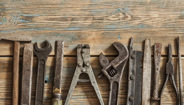 Collection of vintage carpentry tools on an old workbench: woodw