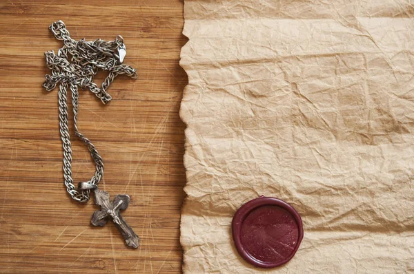 Close-up van zilveren christelijke kruis op oud papier — Stockfoto