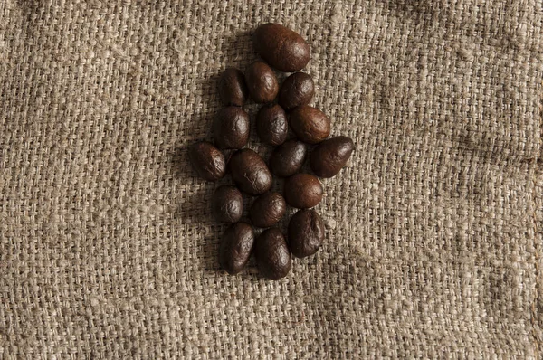 Coffee beans on a rough sacking — Stock Photo, Image