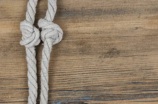 Close up of wooden panels with knot rope — Stock Photo, Image