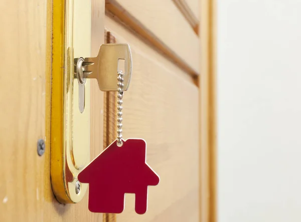 A key in a lock with house icon on it