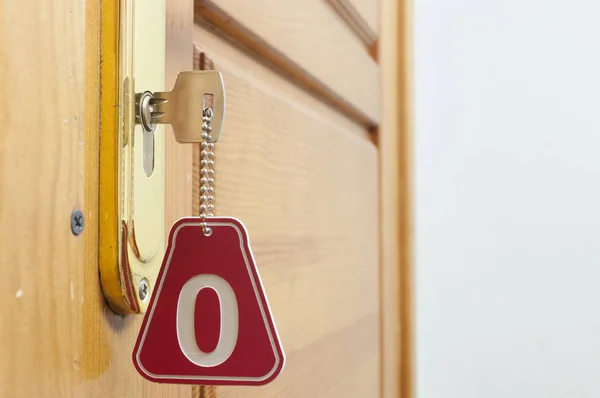 Key in hotel room's door — Stock Photo, Image