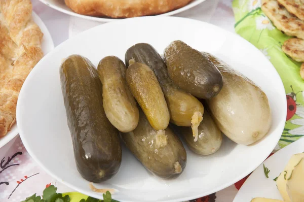 Marinated cucumbers gherkins on table — Stock Photo, Image
