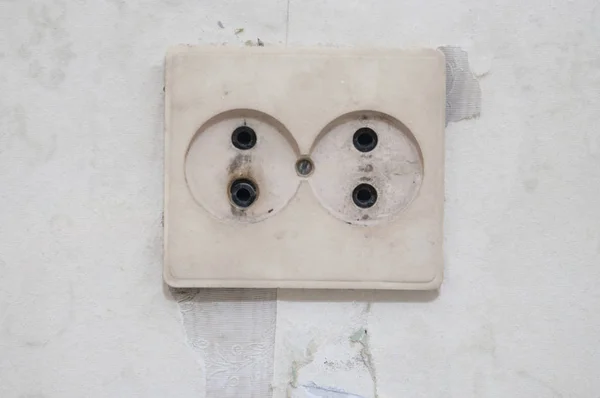 Old white electric socket on wall. — Stock Photo, Image