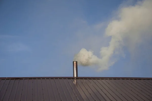 Smoke coming out the chimney against sky
