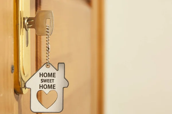 A key in a lock with house icon on it — Stock Photo, Image