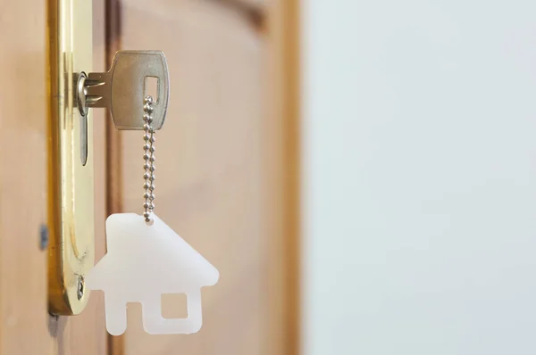 A key in a lock with house icon on it — Stock Photo, Image