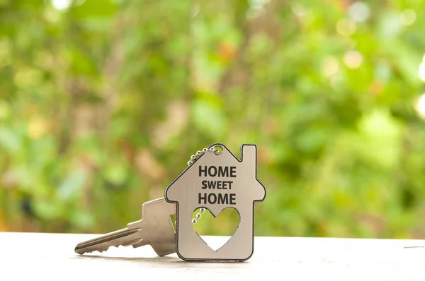 House key on a house shaped keychain. Real estate concept — Stock Photo, Image