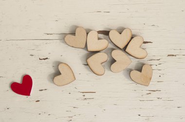 Kırmızı kalp ve beyaz ahşap arka plan üzerinde birçok ahşap kalpler.