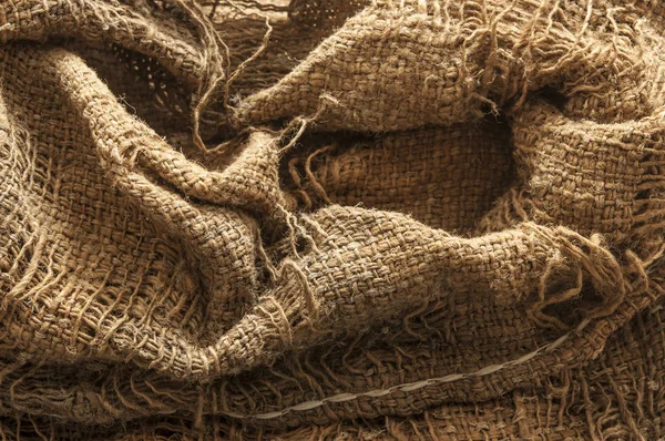Torn burlap decayed. Ragged linen fabric. — Stock Photo, Image