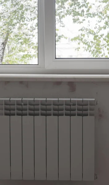 A White heating radiator on the wall. — Stock Photo, Image