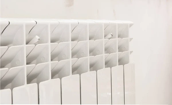 A White heating radiator on the wall. — Stock Photo, Image
