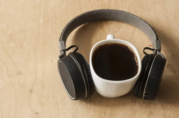 Smartphone, headphones, and a cup of coffee — Stock Photo, Image
