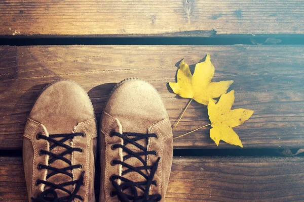 Conceptual image of legs in boots and autumn leaves. — Stock Photo, Image