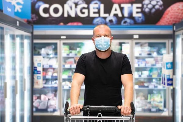 Buyer wearing a protective mask shopping in supermarket during coronavirus pneumonia outbreak. Protection and prevent measures while epidemic time.