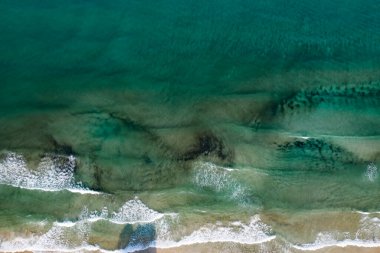 Tropikal kumlu sahil ve kristal berrak turkuaz suyla mavi okyanus manzarası. Soyut yaz arkaplanı.