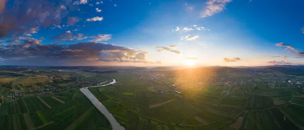 Sunset, aerial, atmospheric view on curving river Somesul in Transylvani, Romania. Beautiful romanian countryside-drone view.