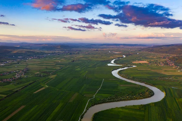 Sunset, aerial, atmospheric view on curving river Somesul in Transylvani, Romania. Beautiful romanian countryside-drone view.