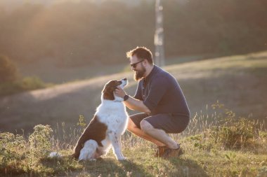 Köpeğine şefkat ve ilgi gösteren mutlu bir adam.