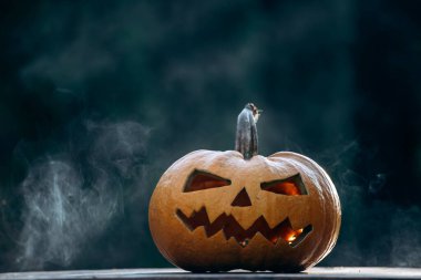 Scary Halloween background with Jack'o'lantern Halloween pumpkins glowing in the nigh