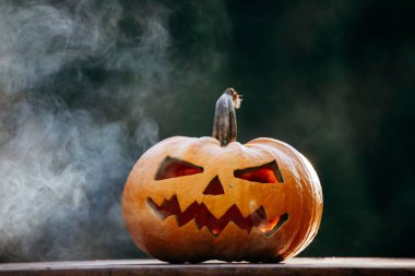 Scary Halloween background with Jack'o'lantern Halloween pumpkins glowing in the nigh