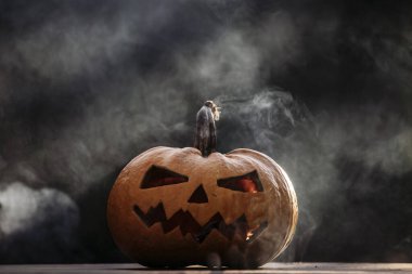 Scary Halloween background with Jack'o'lantern Halloween pumpkins glowing in the nigh