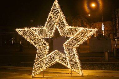 Christmas lights in the shape of a star, holiday bokeh frame.