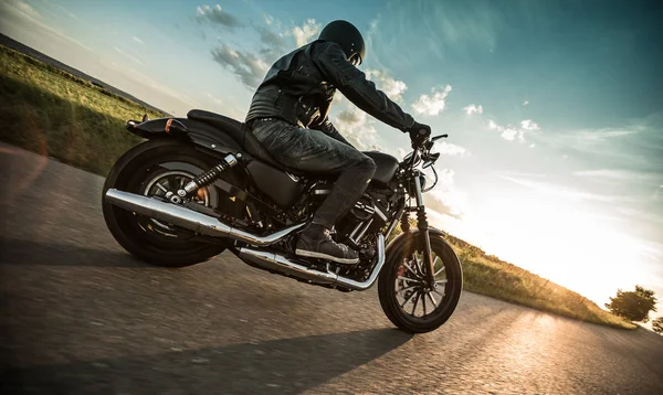 Mann fährt Sportster Motorrad bei Sonnenuntergang. — Stockfoto