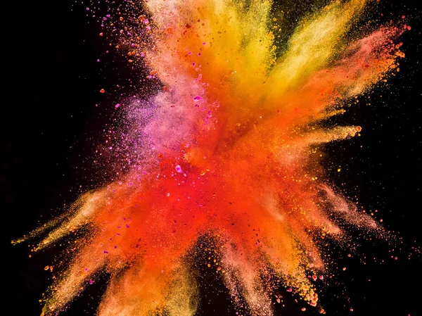 Explosão em pó colorido isolado no fundo preto . — Fotografia de Stock