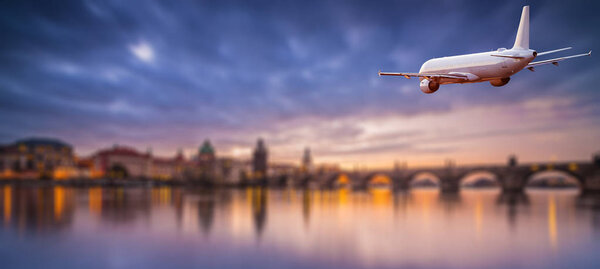 Commercial airplane flying above dramatic clouds.