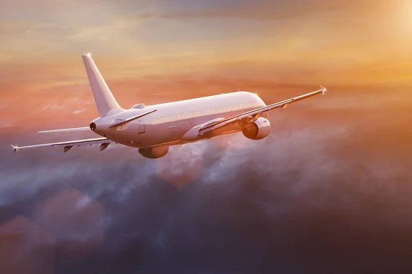 Commercial airplane flying above dramatic clouds. — Stock Photo, Image