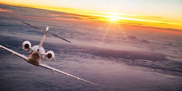 Private jet plane flying above dramatic clouds.