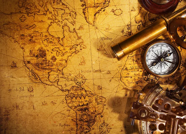 Old vintage navigation equipment on old world map. — Stock Photo, Image