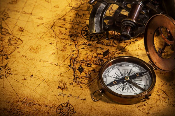 Old vintage navigation equipment on old world map. — Stock Photo, Image