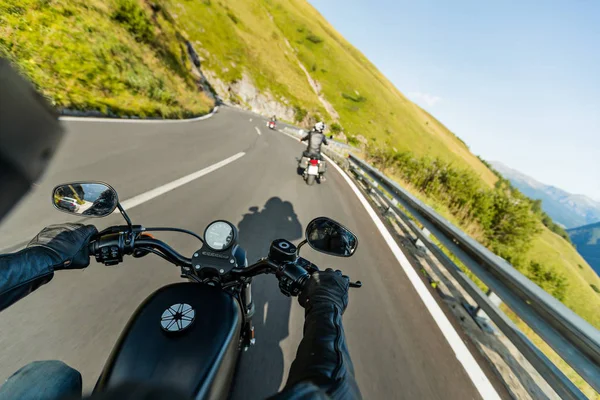 Motorcycle driver riding in Alpine highway, handlebars view, Austria, Europe. — Stock Photo, Image