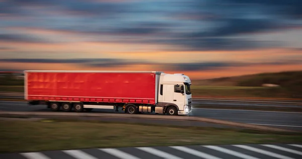 Truck with container on road, cargo transportation concept. Royalty Free Stock Photos