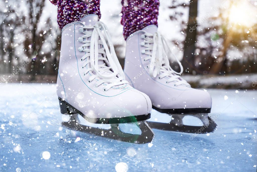 Close-up of woman ice skating on a pond on a freezing winter day