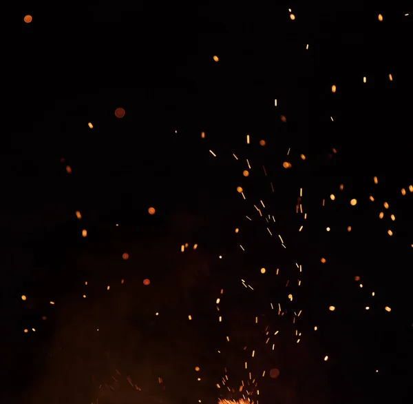 Égő szikra repül. Gyönyörű lángok háttér. Stock Fotó