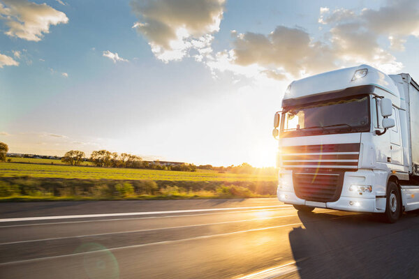 Truck with container on road, cargo transportation concept.