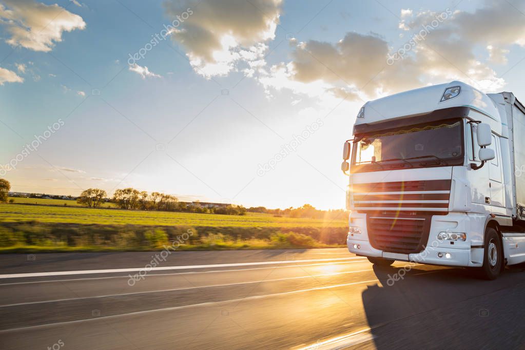 Truck with container on highway, cargo transportation concept. Shaving effect.