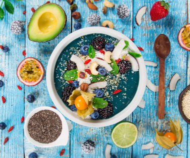 Taze böğürtlen, fındık, tohum, meyve ve sebzeli meyve suyu kasesi..